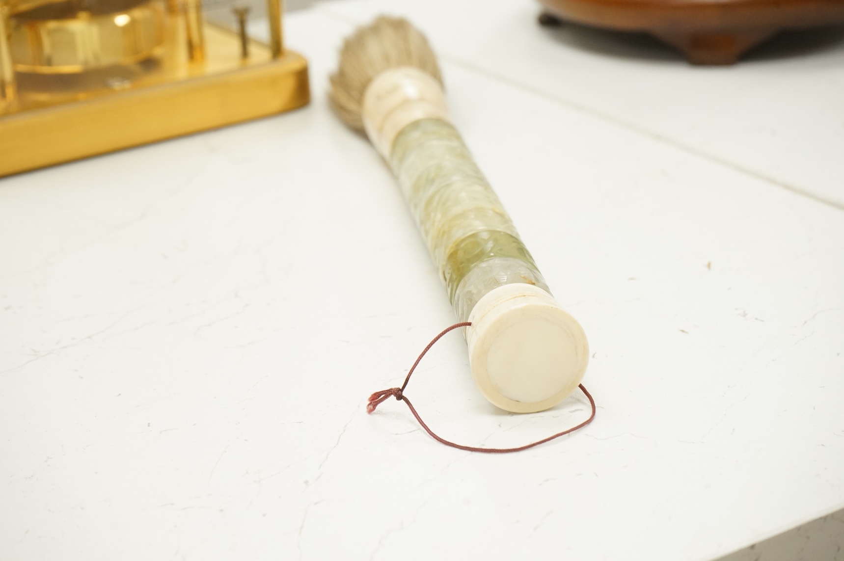 A carved jadeite and bone fly whisk, 39cm long